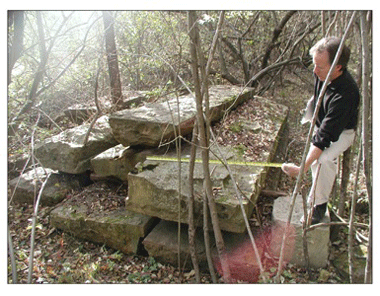 Brian Gorecki examines stonework from historic Old Main.
