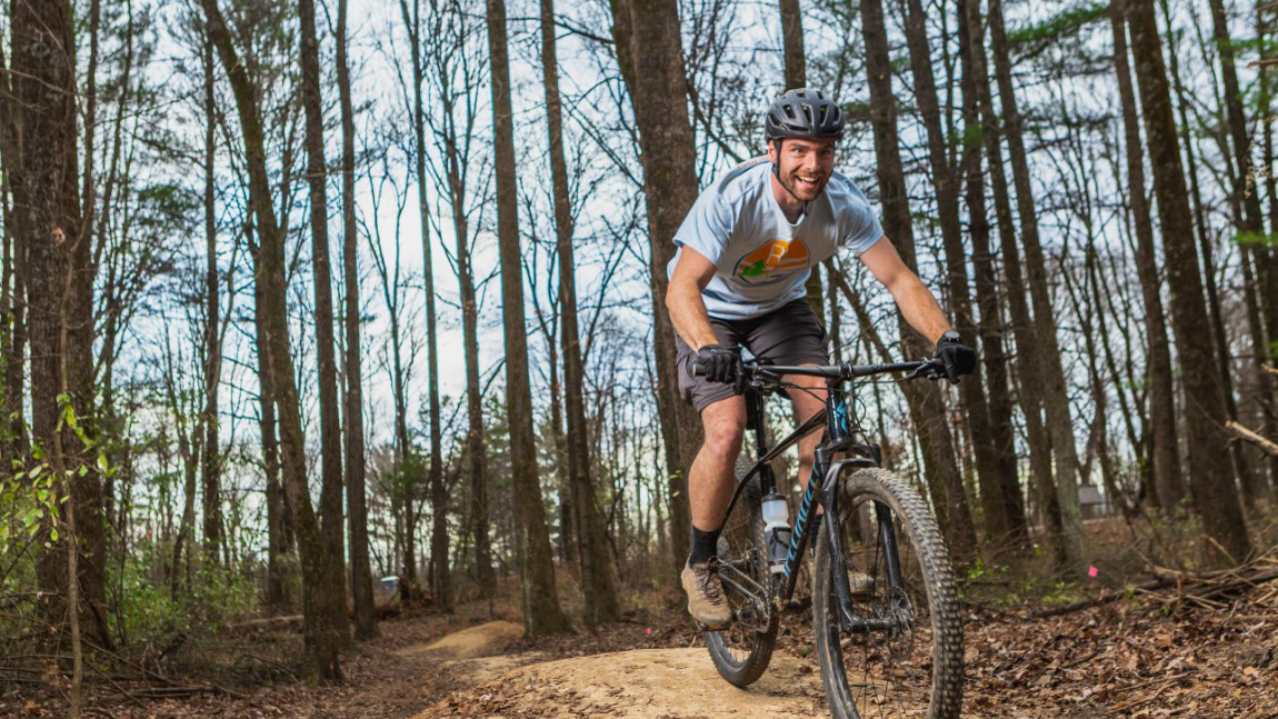 man riding a bike on a bike trail