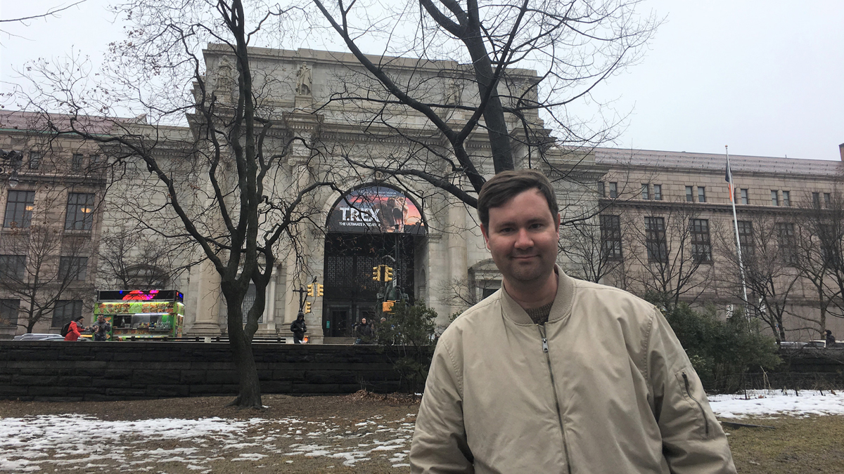 man standing outside the American Museum of Natural History in New York City