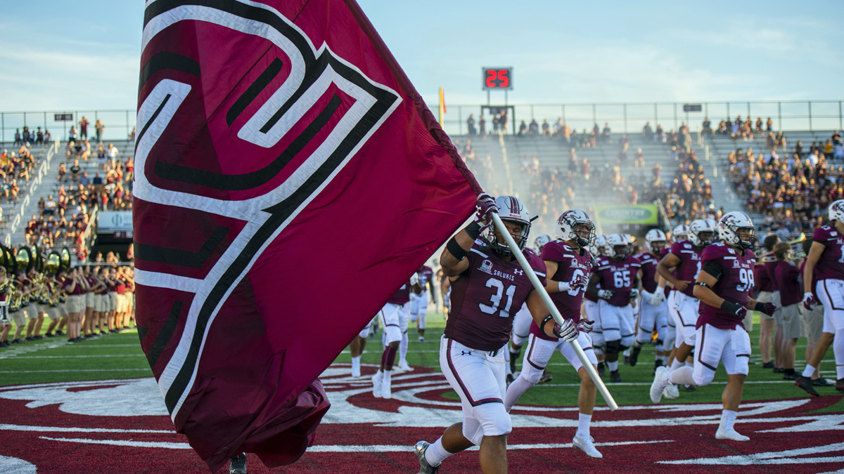 football players running onto the field