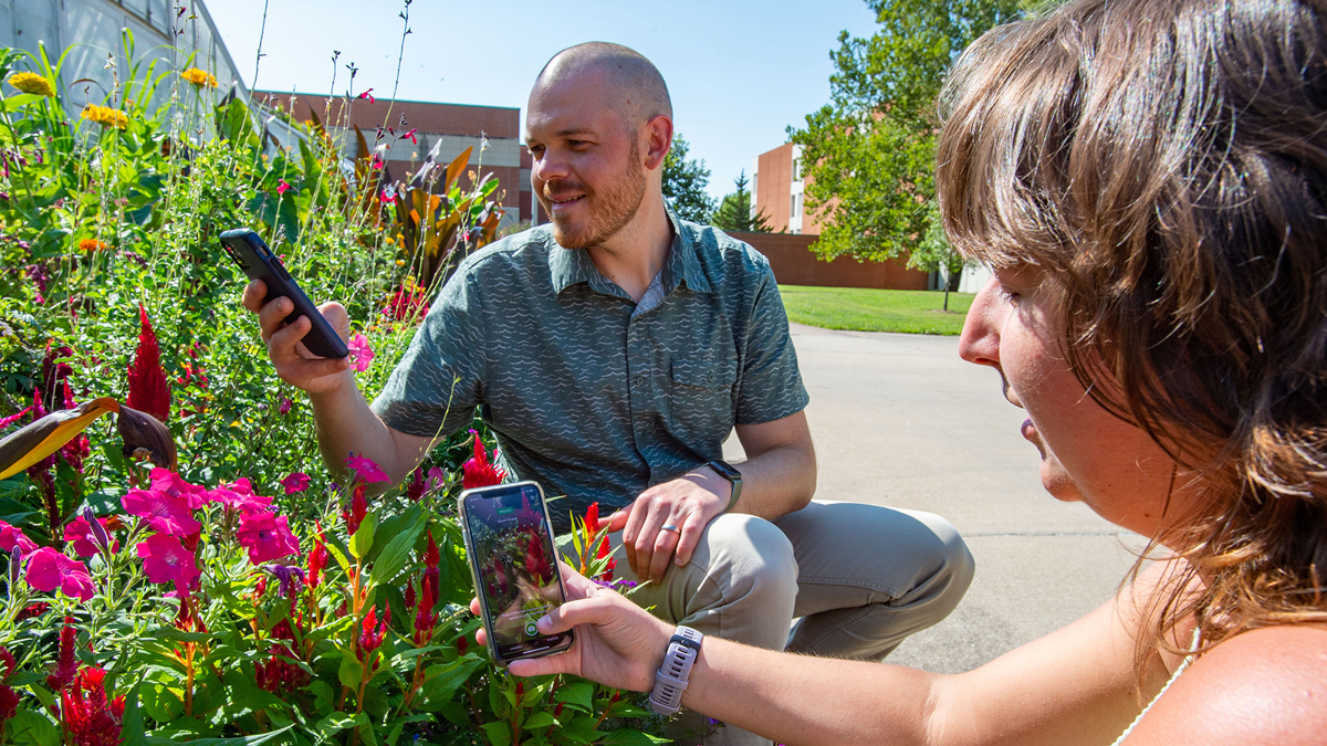 professor and student identifying different species of life on campus