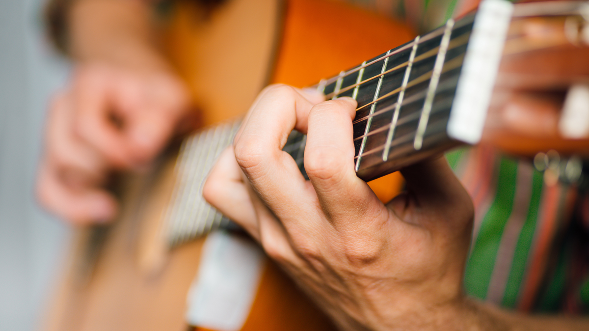 fingers on a guitar