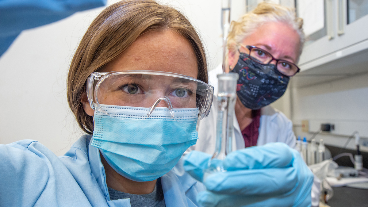 student and professor in a lab