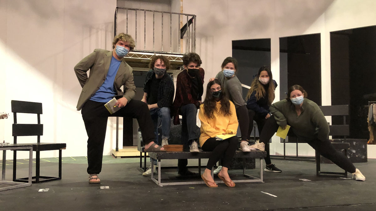 Hay Fever publicity photo - people on a stage, looking at the camera, wearing masks