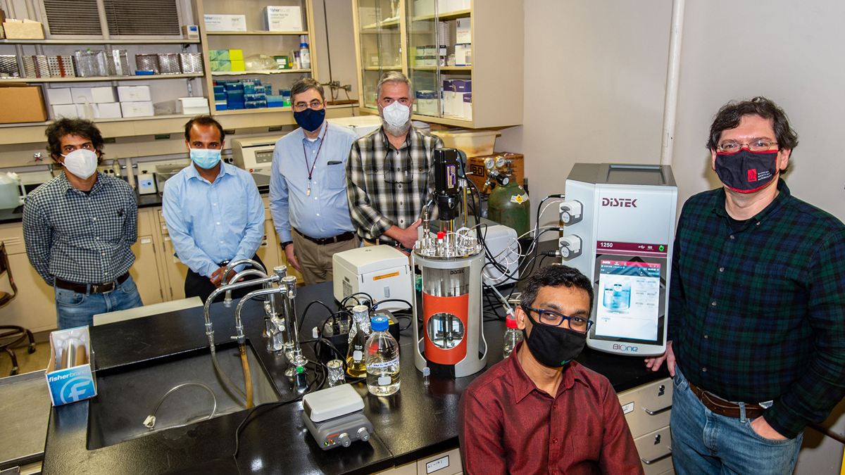 research team in a lab wearing masks