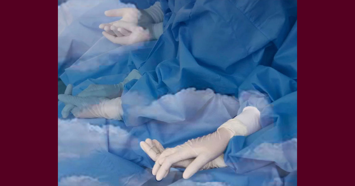 bodies in blue surgical gowns and rubber gloves