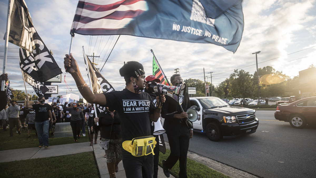 black people protesting and waving flags