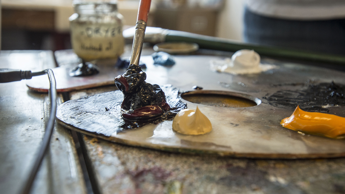 paint on a pallet, with a brush