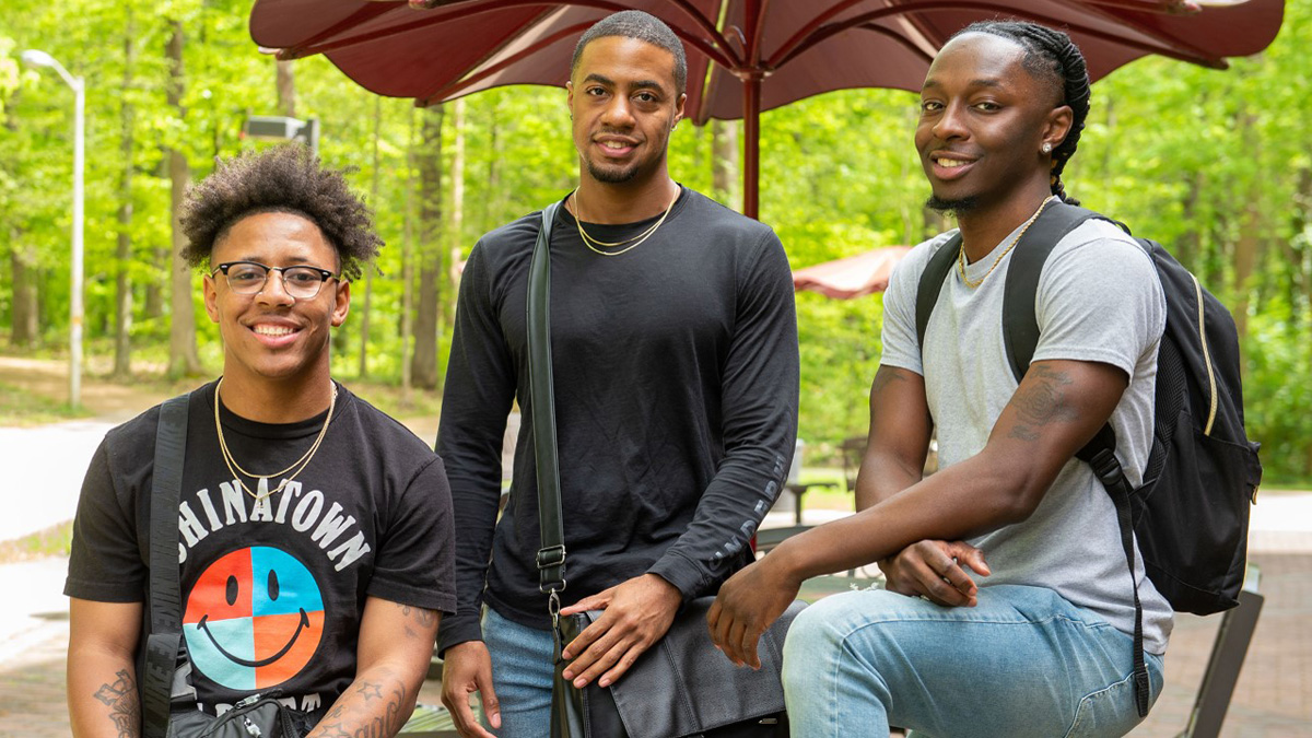 three young men, cousins, smiling at the camera