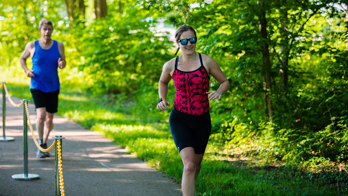 man and woman running in a triathalon