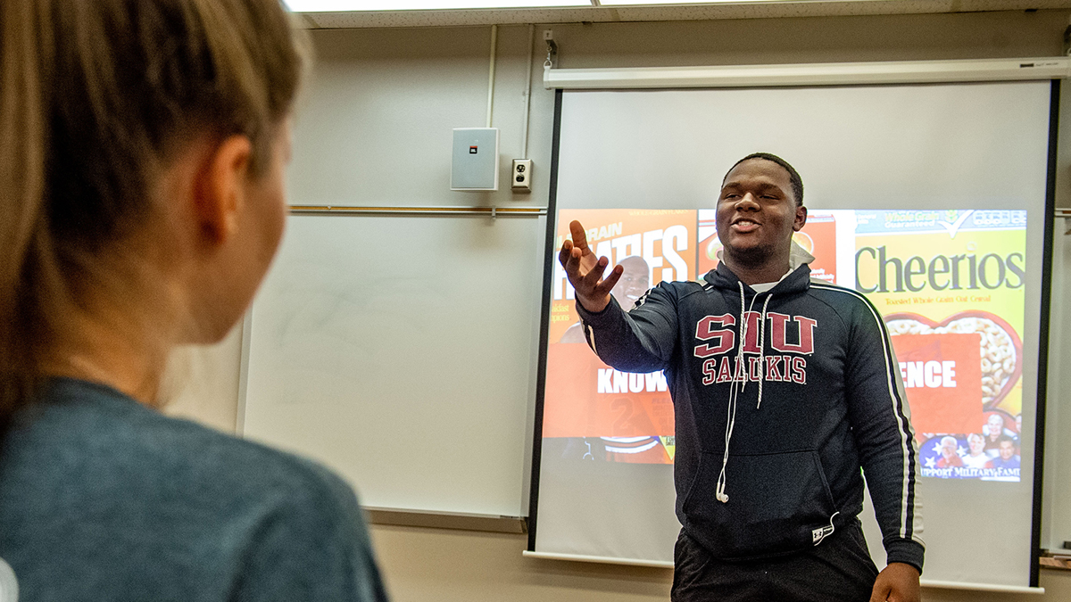 young black man giving a presentation