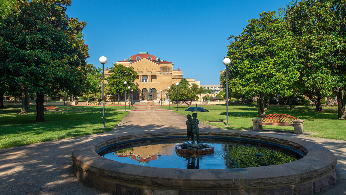 a fountain with a building in the background