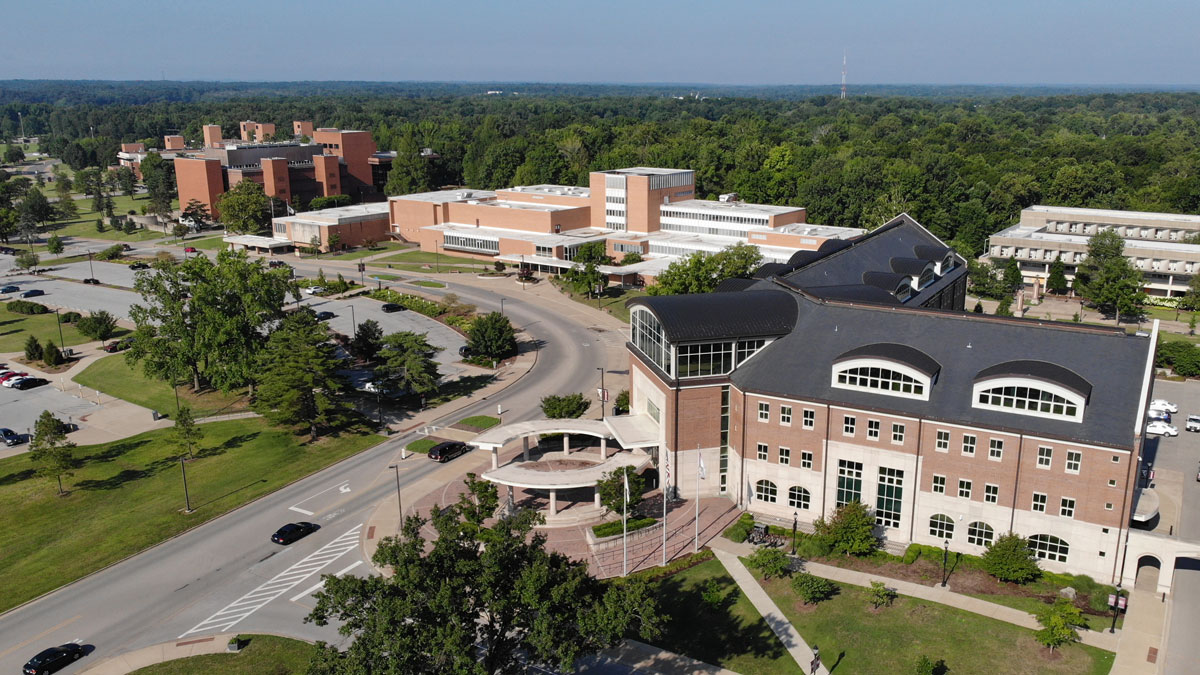 aerial photo of the campus at Southern Illinois University Carbondale. The view is above the Student Services Building, looking west/southwest. The Student Center, Neckers and Faner are visible  in the background.