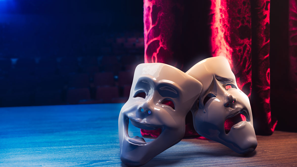 comedy and tragedy masks on a stage, with stage lights