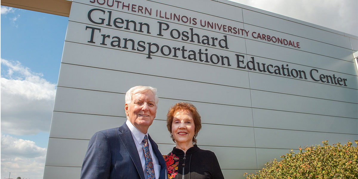 Glenn and Jo Poshard, standing in front of the newly named Glenn Poshard Transportation Education Center