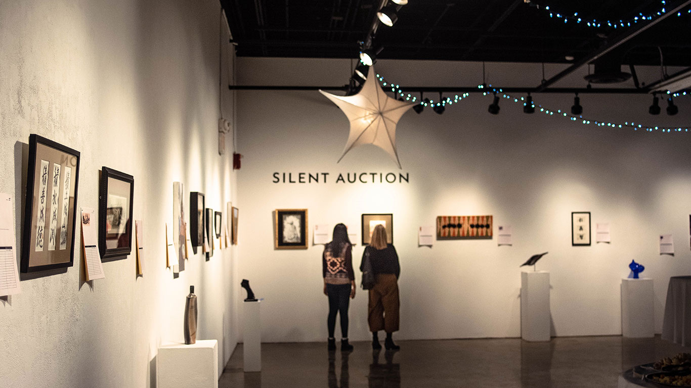 Art Over Easy 2019 Guests looking at artwork.