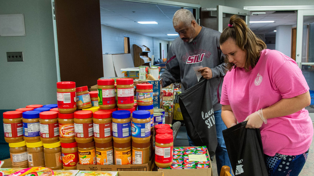 Man and woman loading groceries at a food pantry