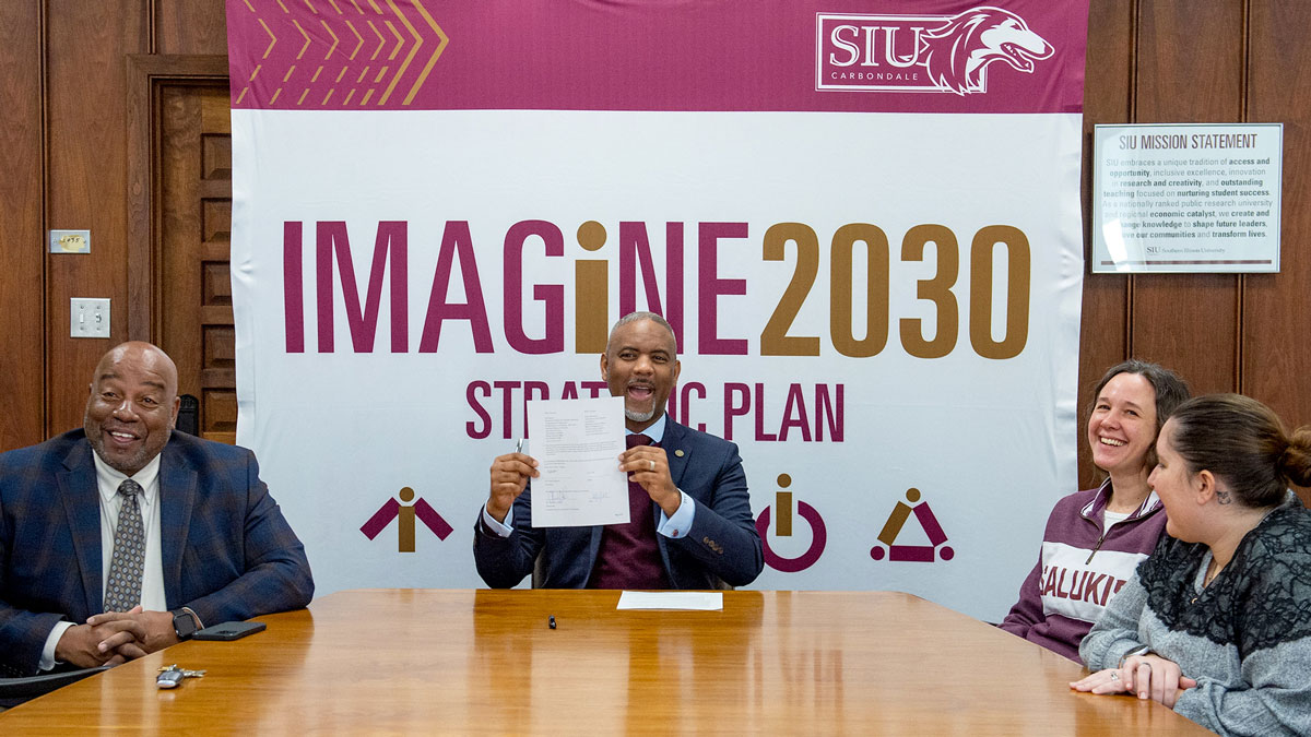 Officials from SIU celebrate the signing of a new agreement.