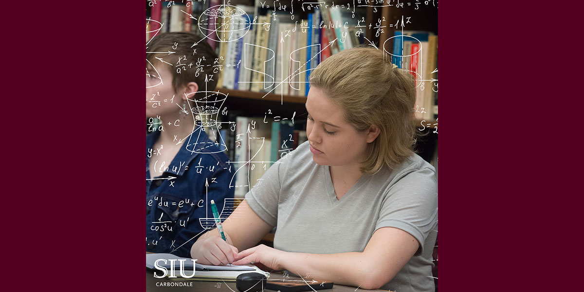 young woman working at a desk, surrounded by the images of equations.