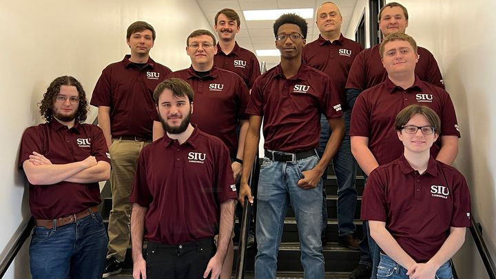 Security Dawgs team, assembled on a staircase