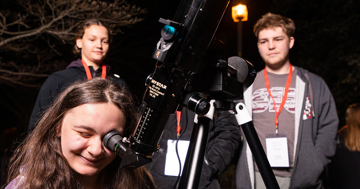 siu students looking through telescope