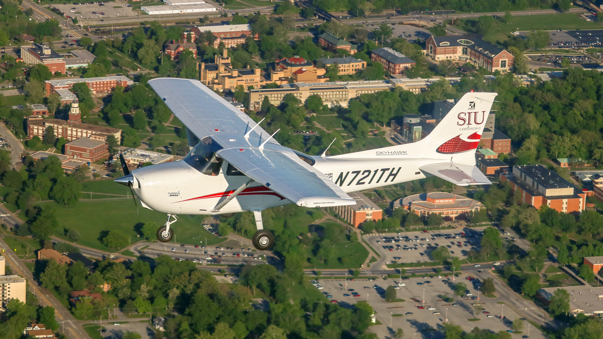 Cessna airplane, in flight, over Southern Illinois University