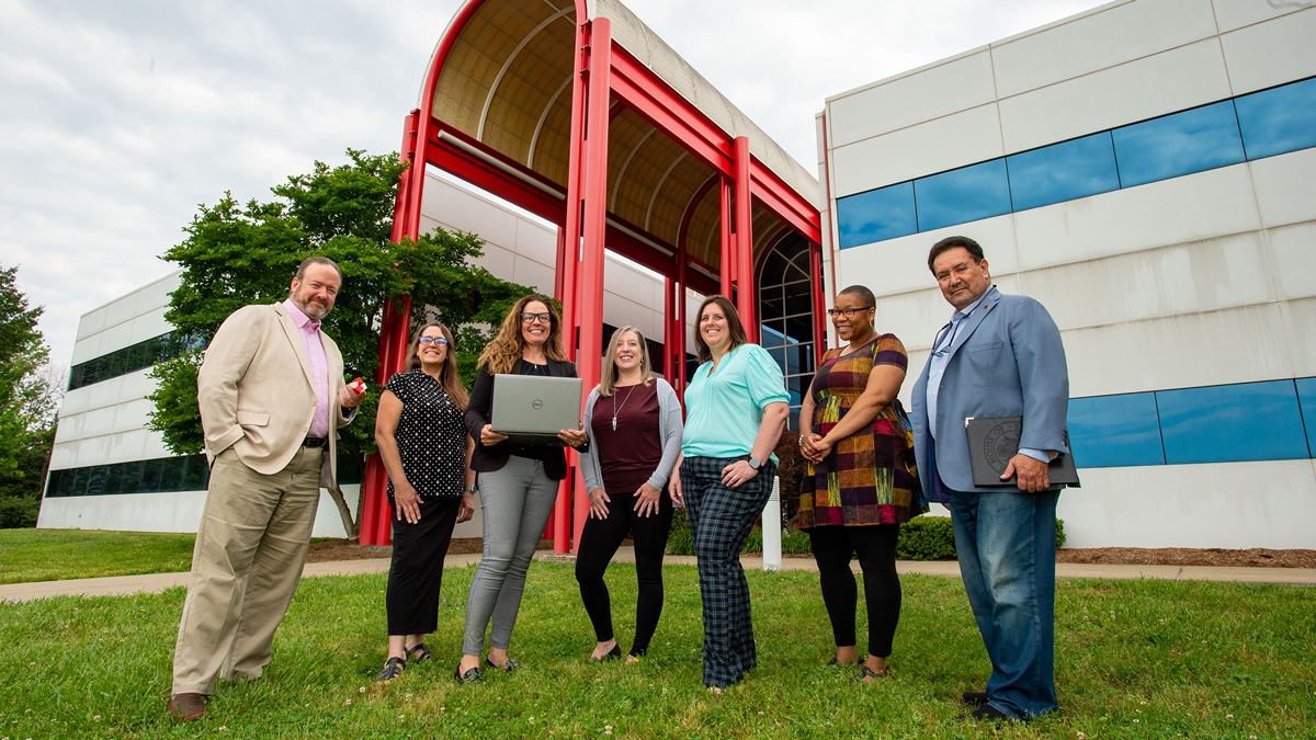 group of people standing in front of the Dunn Richmond Economic Development Center