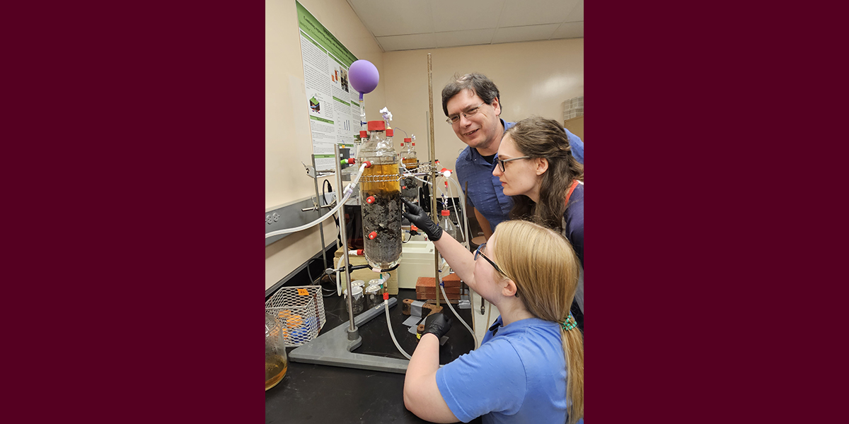 Three people working in a lab.