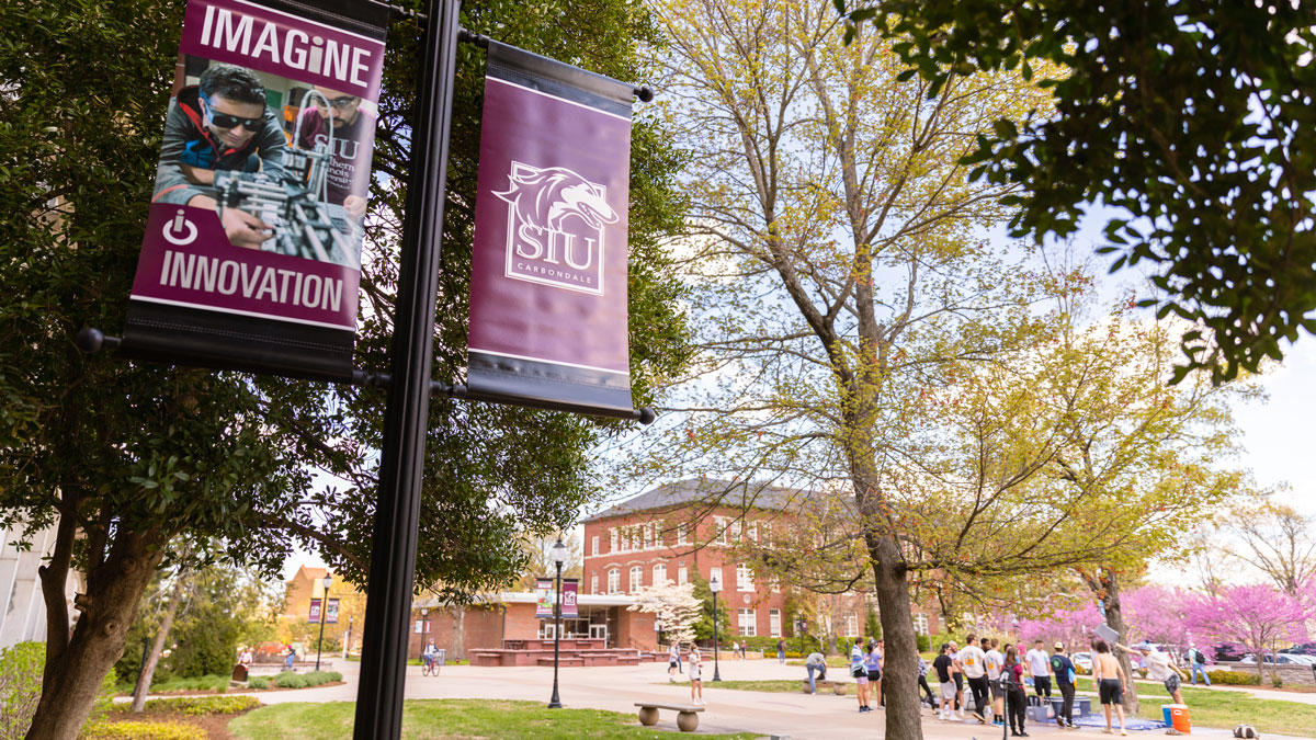 Banner on light posts displaying the new SIU logo