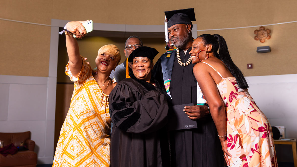 Group of people taking a selfie after a graduation ceremony