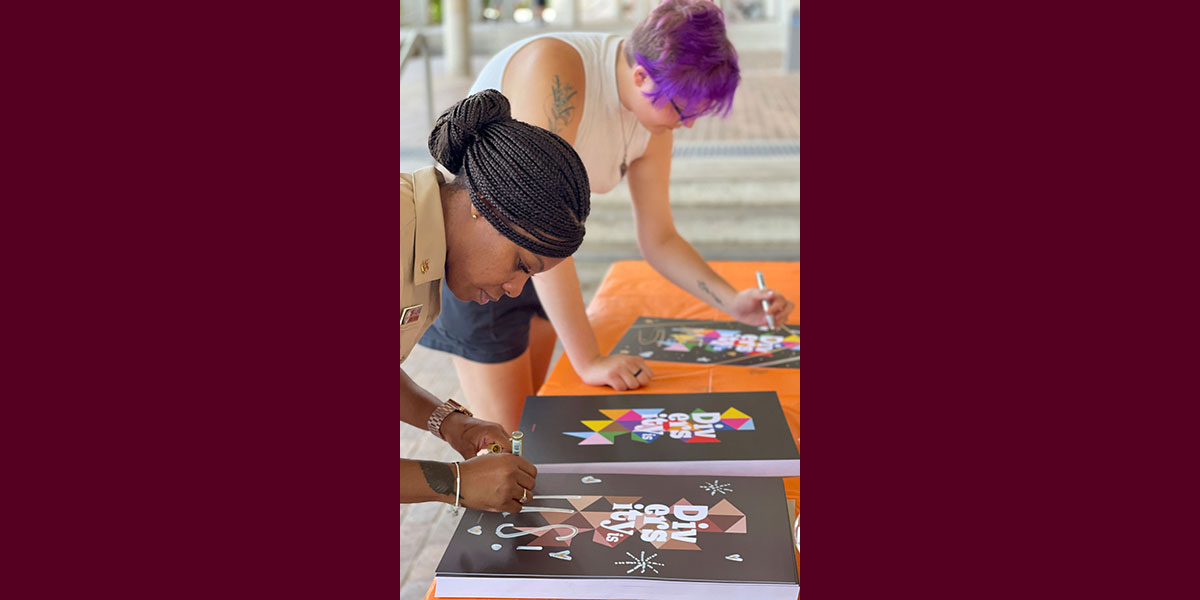 two women making posters