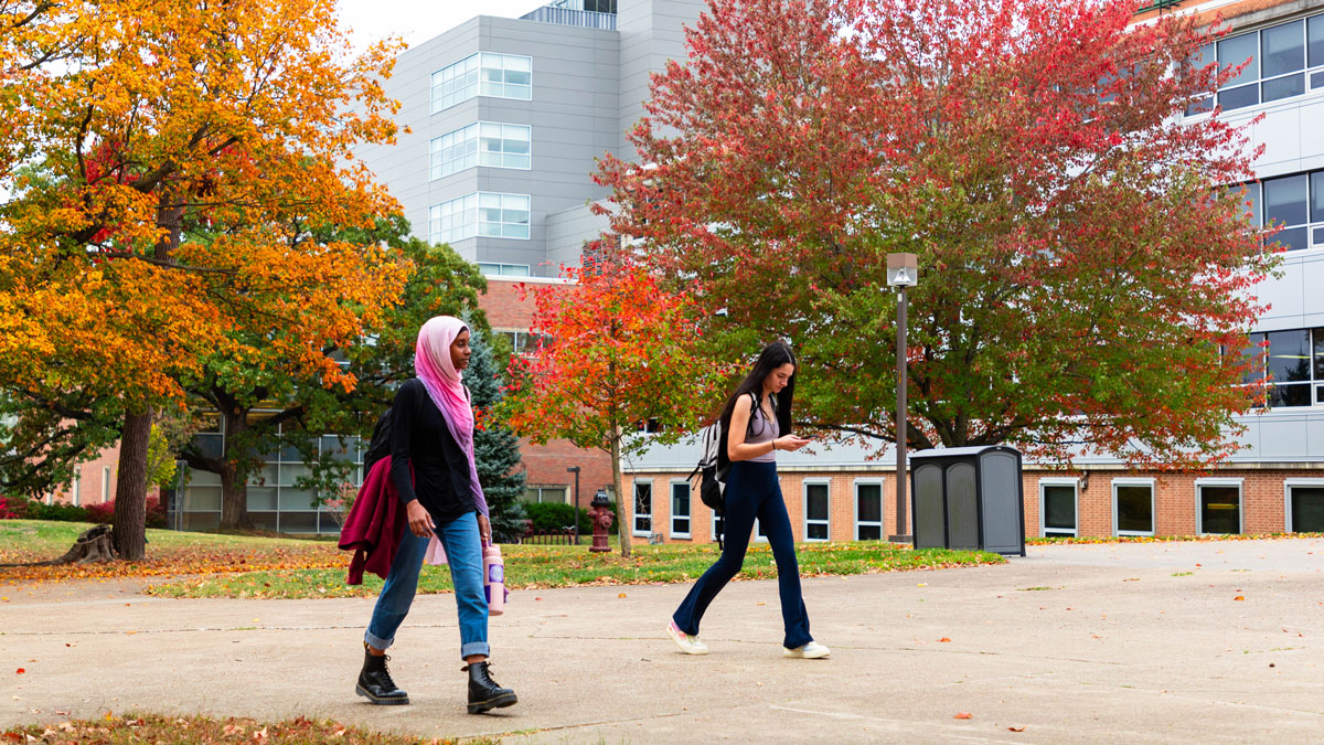Two young women are seen walking on campus