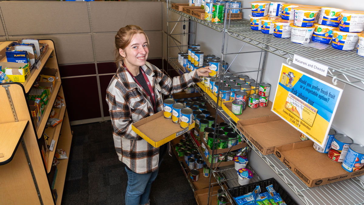 young woman stocking shelves in a food pantry