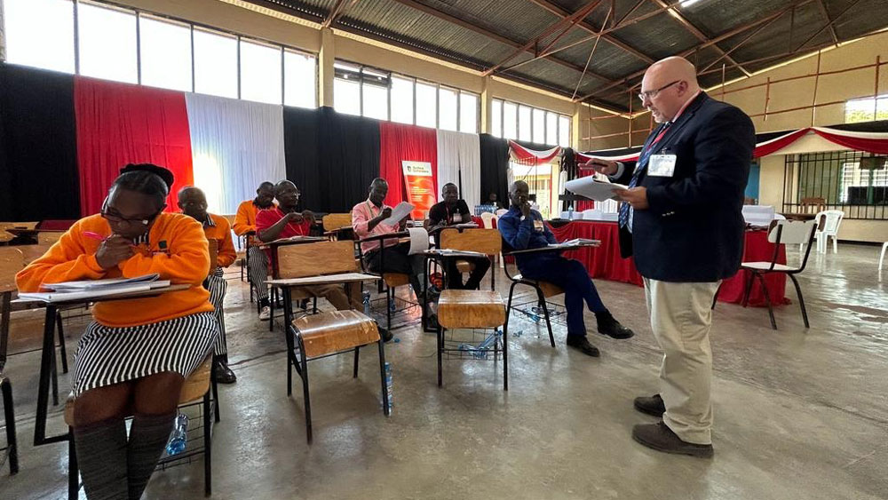 Chris Behan, right, a professor at the SIU School of Law, teaching a group of prisoners during a visit to Kenya in July. 