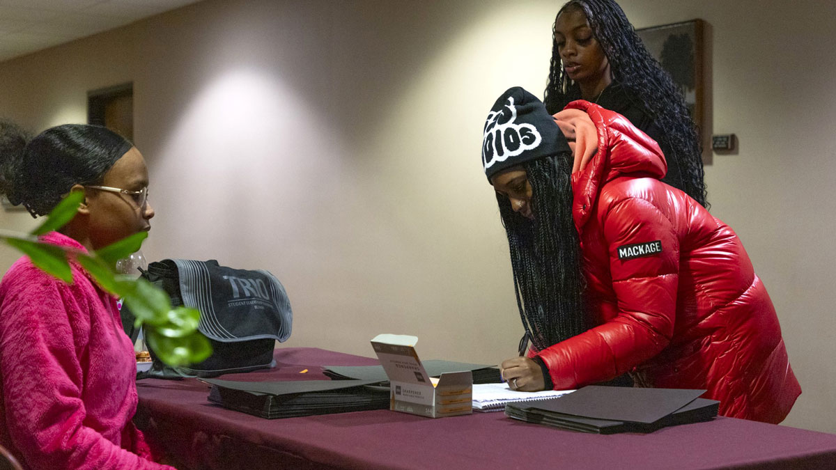Young black women are signing a registration list