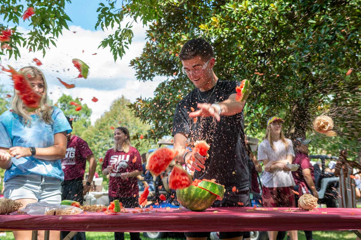 A student is seen at a table, as a watermelon is exploding.