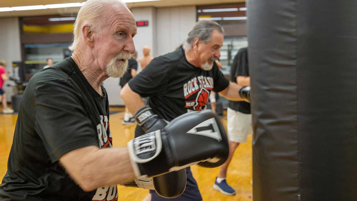 Two older men, boxing