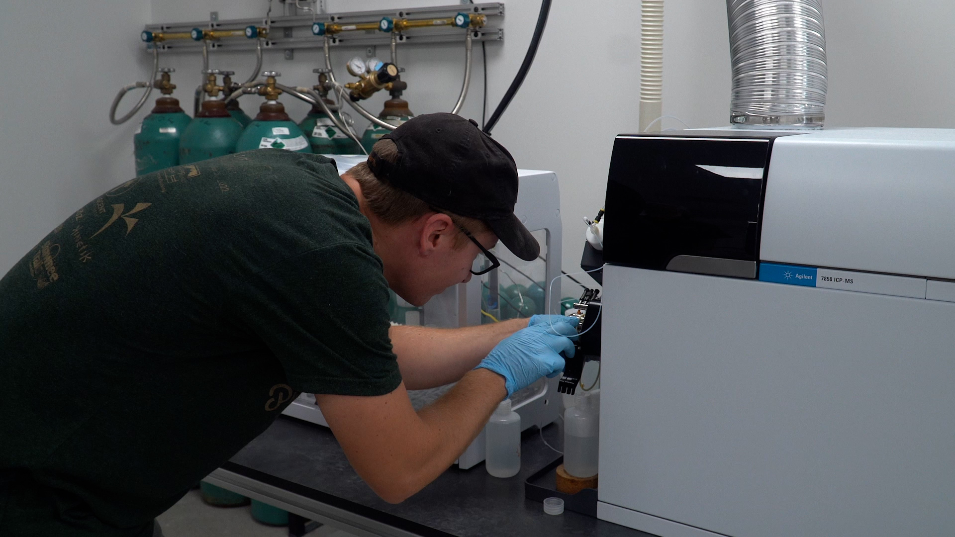 A worker adjusts equipment in a lab