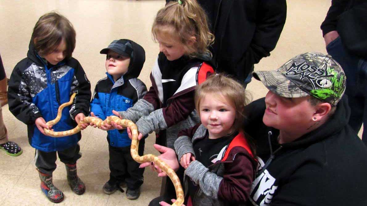 Image of children getting to handle a live snake