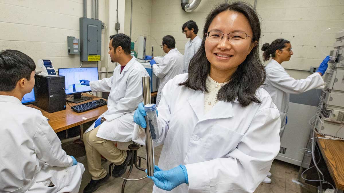 Several people are seen working in a lab