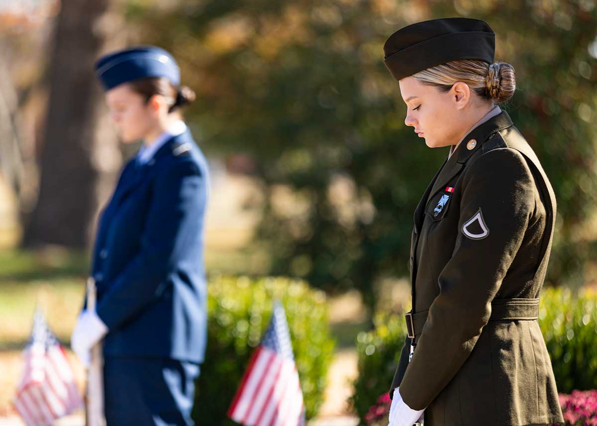 Two ROTC members stand vigil at the flagpole for Veterans Day