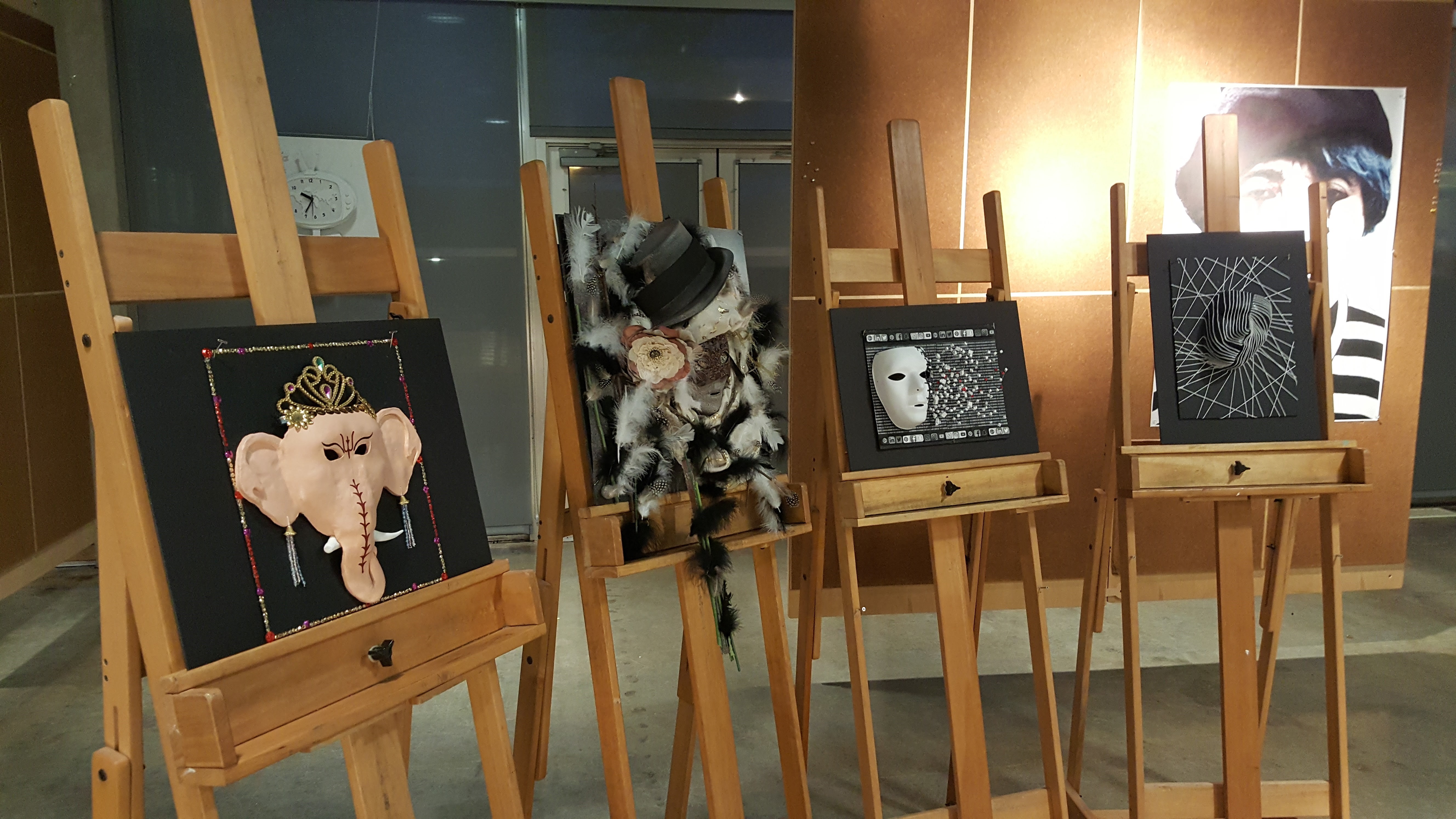 A row of masks, displayed on easels