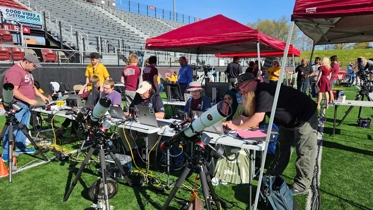 SIU students and volunteers working with telescopes at the eclipse.