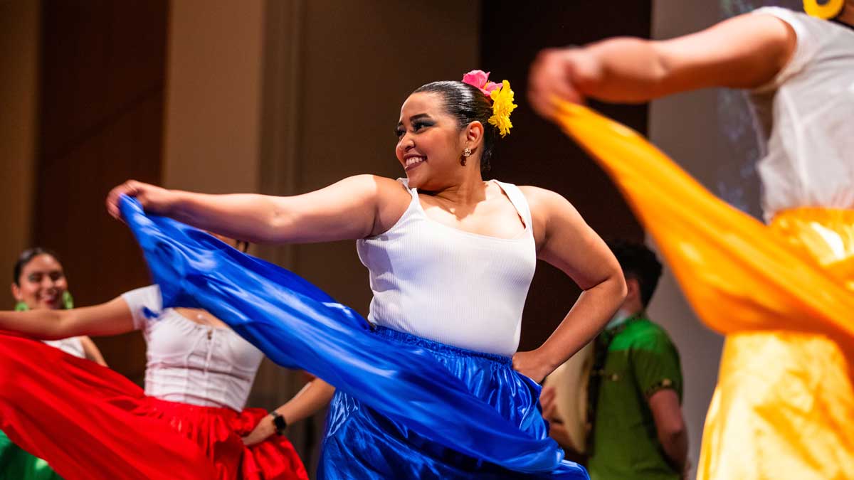 Women dancing in brightly colored skirts.