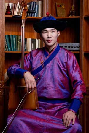 A man is holding a Mongolian horse-headed fiddle.