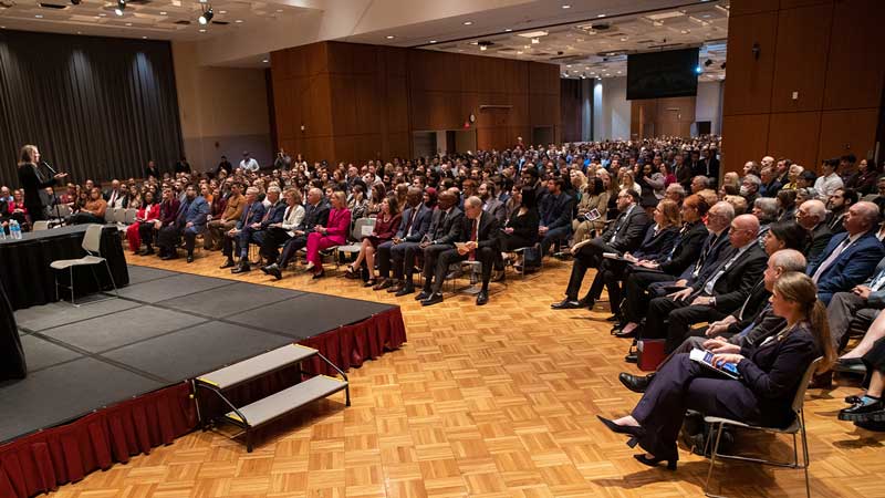 People seated in a large room.