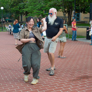 A man and woman dance at a Sunset Concert.