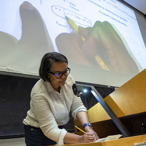 Professor writes on a projector.