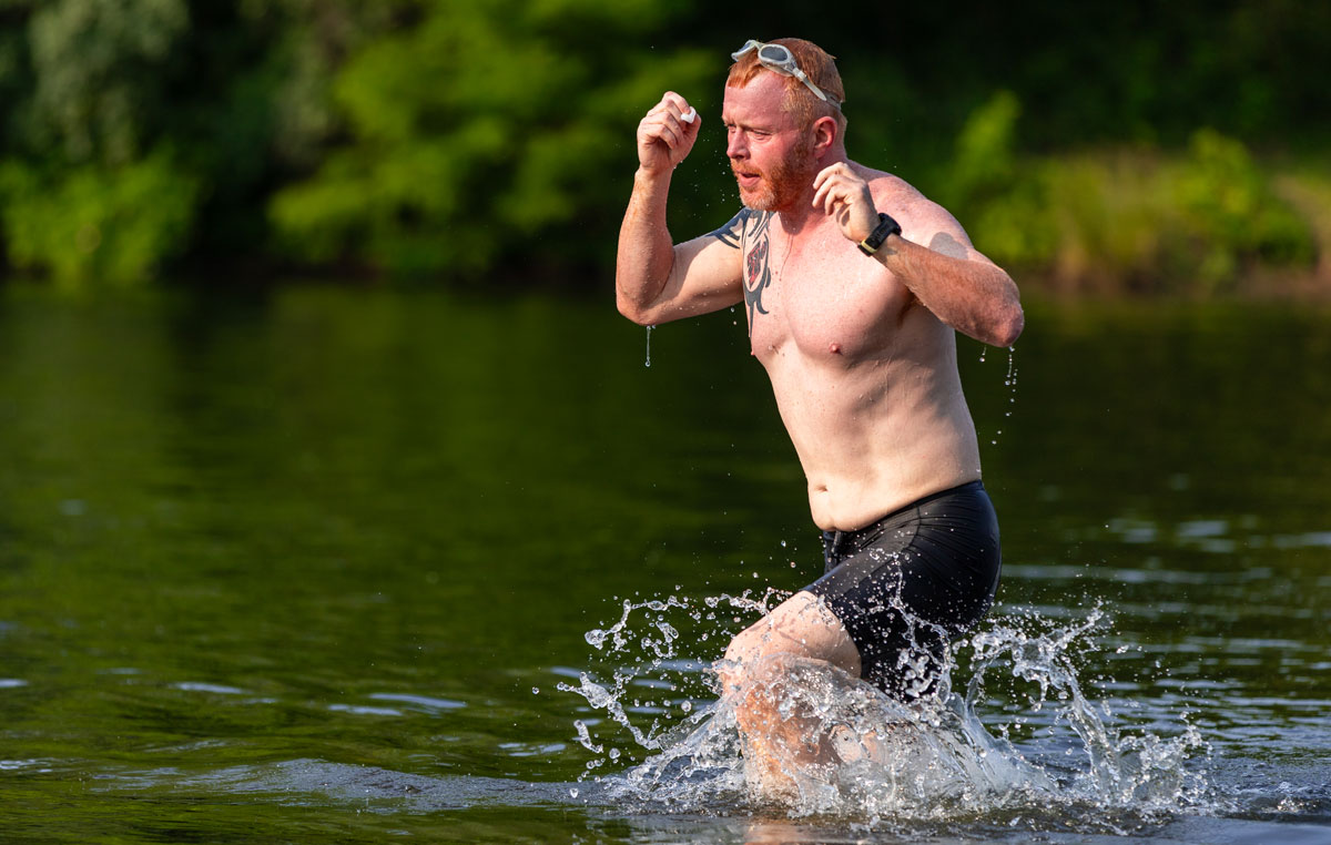 A man heads into the water during a triathalon.