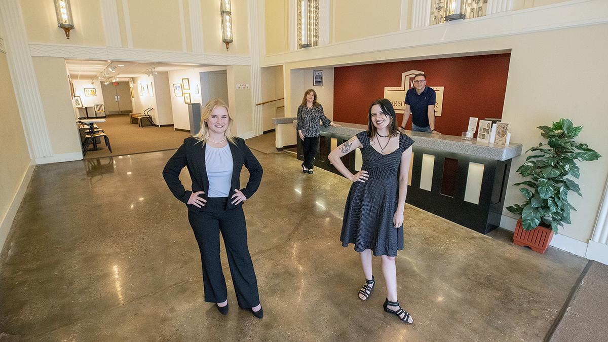 Students and teacher pose in the lobby of the Varsity Theater.